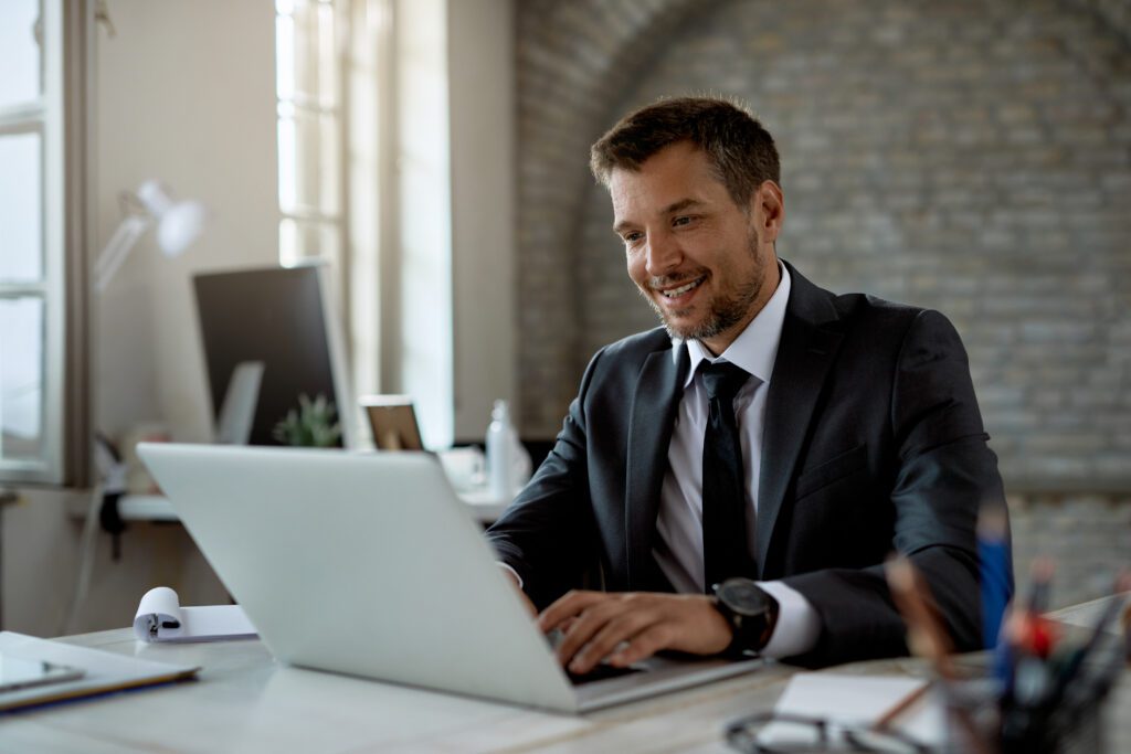 happy male entrepreneur working computer office